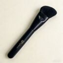 Black angled makeup brush with soft bristles and Soghienia brand logo on matte handle