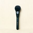 Black Sephonie makeup powder brush with soft rounded bristles and matte handle on cream background