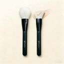 Two Sophienia makeup brushes with white synthetic bristles and black handles, one powder brush and one foundation brush...