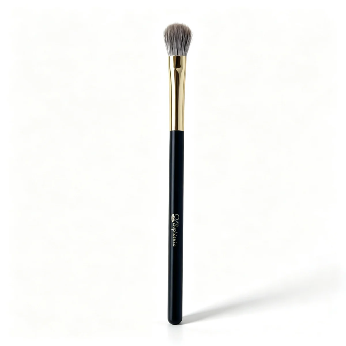 Close detail of fluffy makeup brush bristles and a gold ferrule.